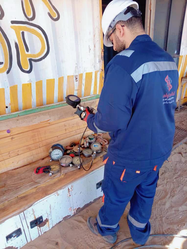 Technician calibrating gauges